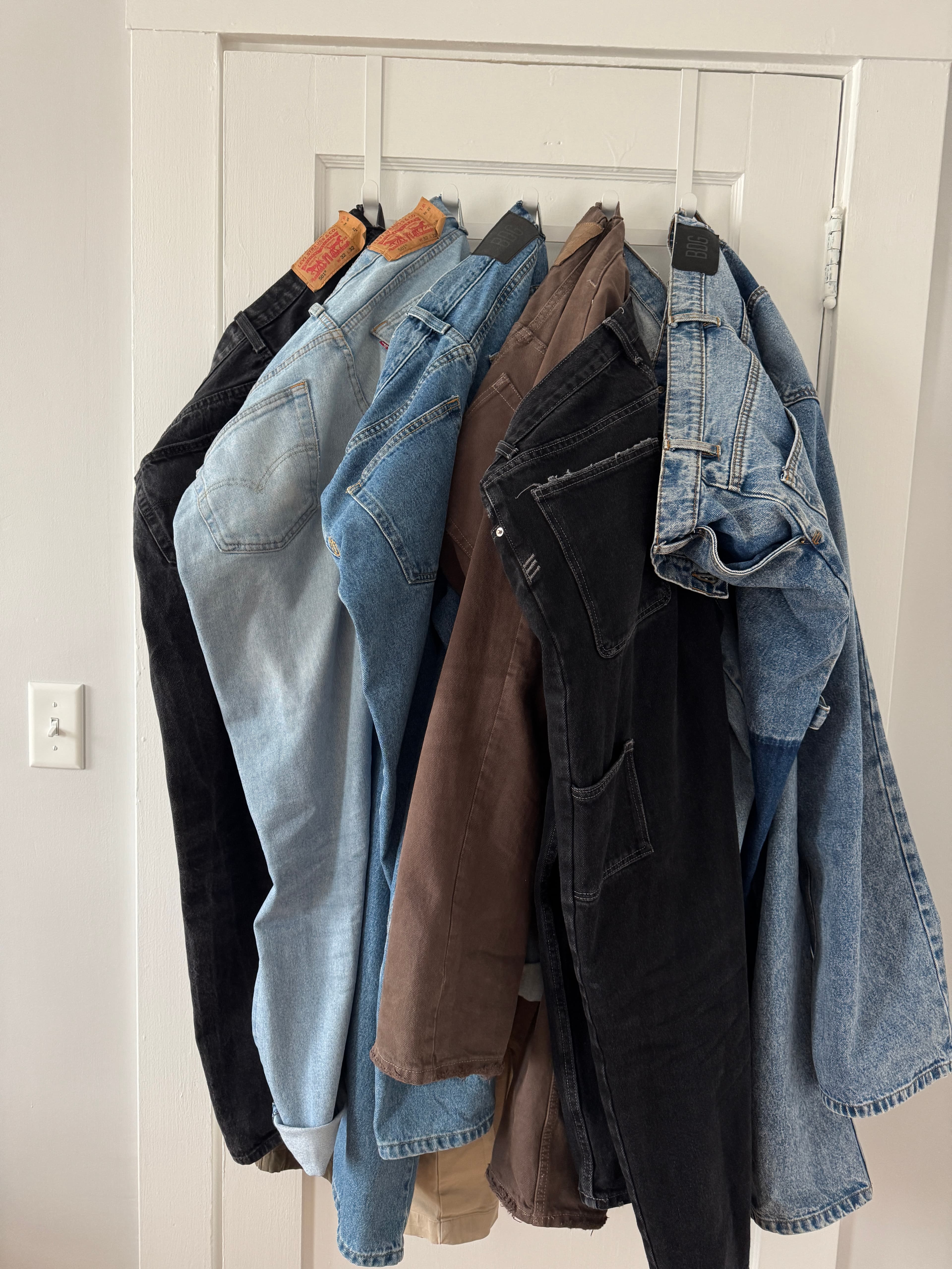 Stack of jeans on a door
